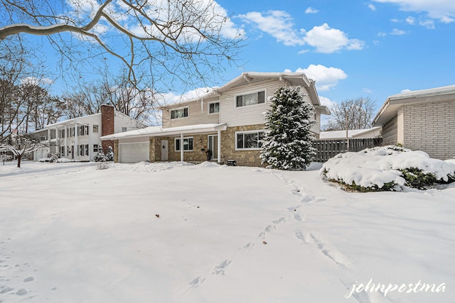 view of snow covered back of property