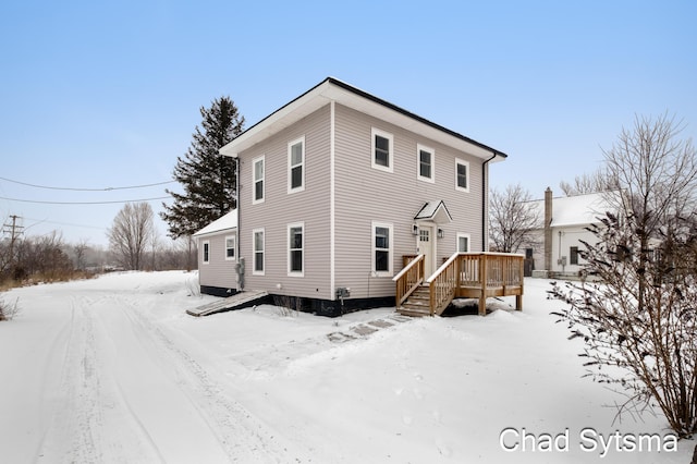 view of snow covered rear of property