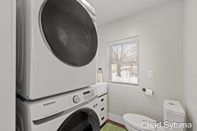 laundry room featuring stacked washing maching and dryer