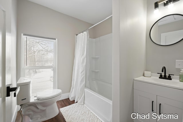 full bathroom featuring vanity, hardwood / wood-style flooring, toilet, and shower / bath combo