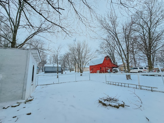 snowy yard with an outdoor structure