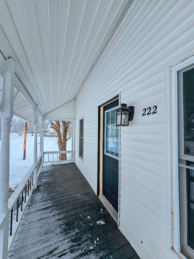 snow covered deck with covered porch