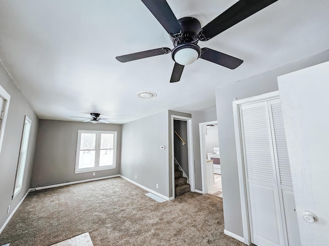 unfurnished bedroom featuring carpet floors and ceiling fan