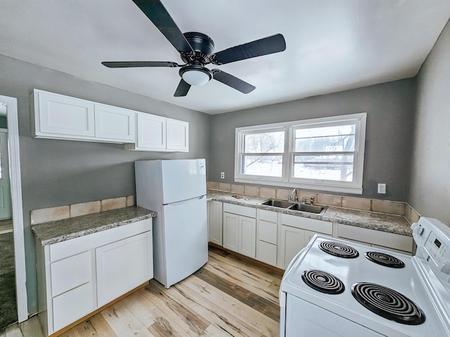 kitchen featuring sink, white cabinetry, light hardwood / wood-style flooring, ceiling fan, and white appliances