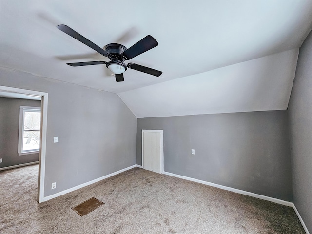 additional living space with lofted ceiling, carpet floors, and ceiling fan