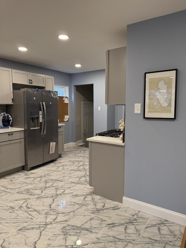 kitchen with gray cabinetry and stainless steel appliances