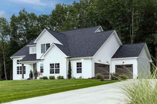 modern inspired farmhouse featuring a garage and a front yard