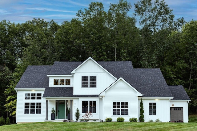 view of front of property with a garage and a front lawn