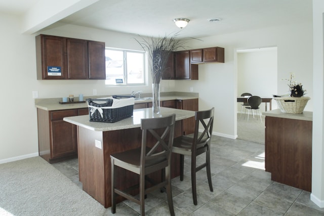 kitchen featuring a kitchen island, sink, and a kitchen breakfast bar