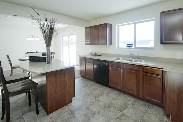 kitchen with pendant lighting, sink, a breakfast bar, dishwasher, and dark brown cabinets