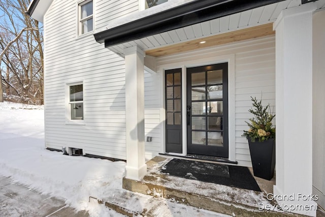 view of snow covered property entrance