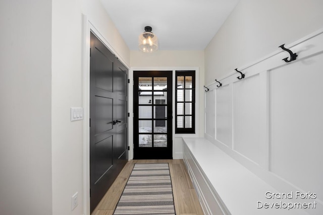 mudroom with wood-type flooring