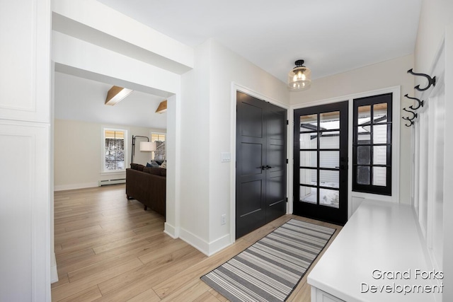 entrance foyer featuring beamed ceiling, a baseboard radiator, and light hardwood / wood-style flooring