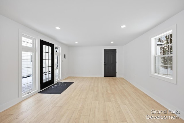 entryway with plenty of natural light and light hardwood / wood-style floors