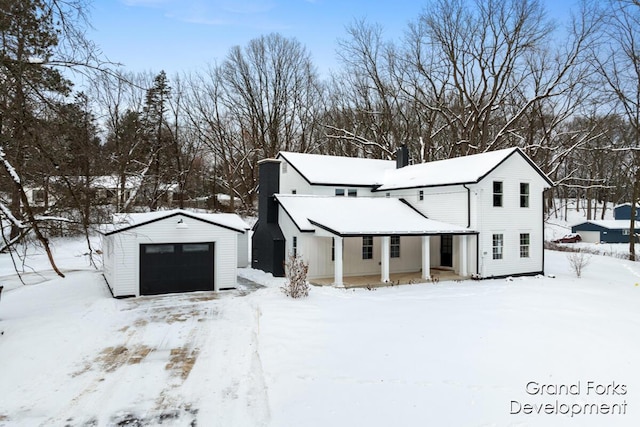 exterior space featuring a garage, an outdoor structure, and covered porch