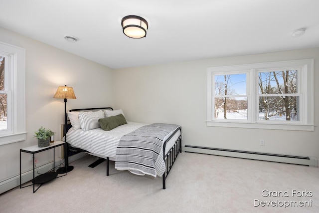 bedroom with baseboard heating and light carpet