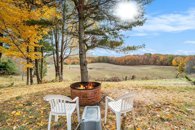 view of yard with a rural view and a fire pit