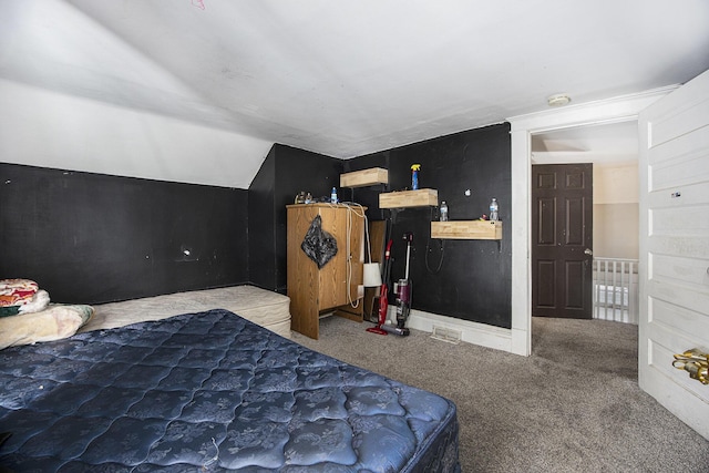 bedroom with vaulted ceiling and carpet flooring