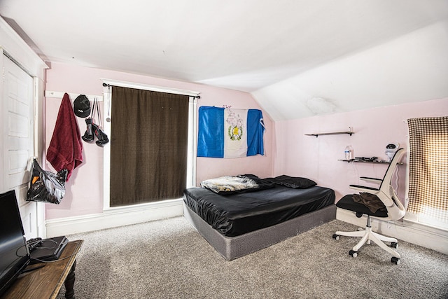 bedroom with lofted ceiling and carpet floors