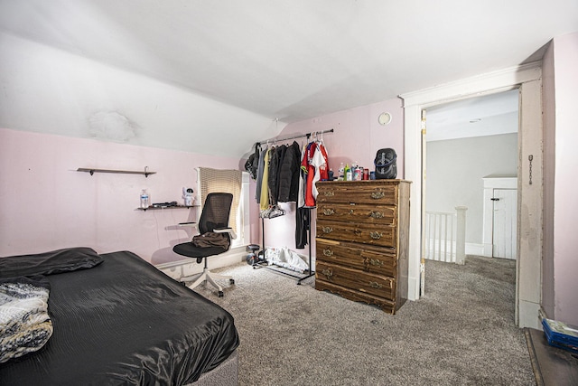 carpeted bedroom with lofted ceiling