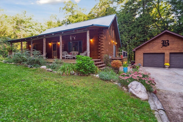 exterior space with a garage, an outdoor structure, covered porch, and a front lawn