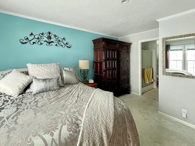 carpeted bedroom featuring crown molding