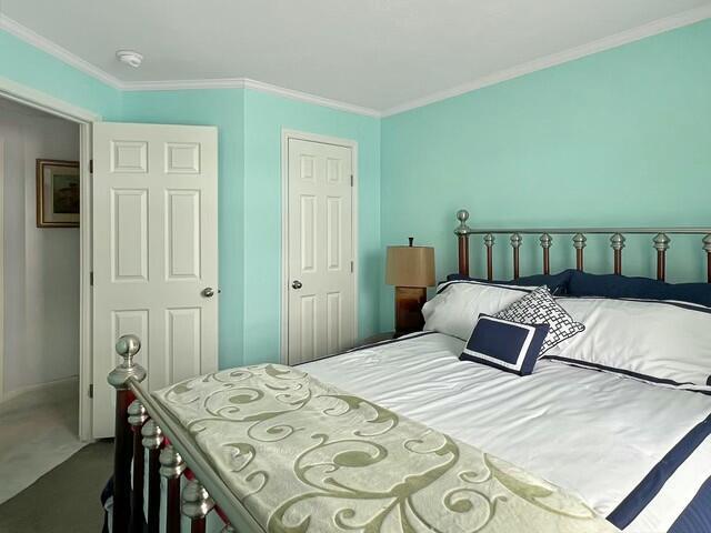 bedroom with carpet and ornamental molding