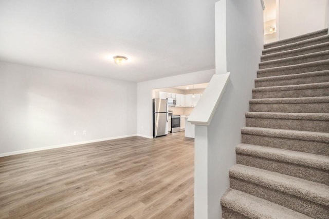 stairs featuring wood-type flooring