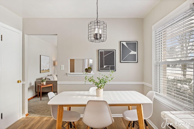 dining space with a chandelier and light hardwood / wood-style flooring