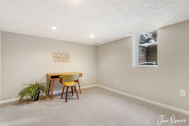 office area with a textured ceiling and carpet