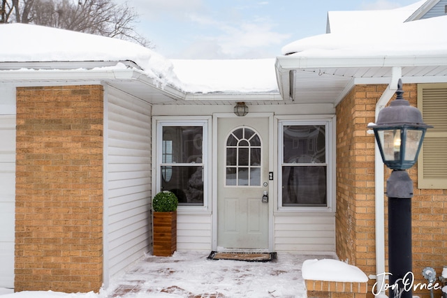 view of snow covered property entrance