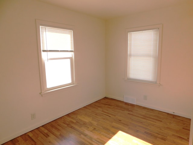 spare room featuring light wood-type flooring