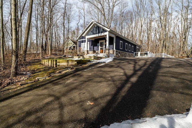 view of front facade featuring covered porch and stone siding