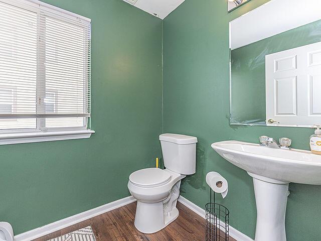 bathroom with sink, hardwood / wood-style floors, and toilet