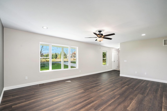 unfurnished room with ceiling fan and dark hardwood / wood-style flooring