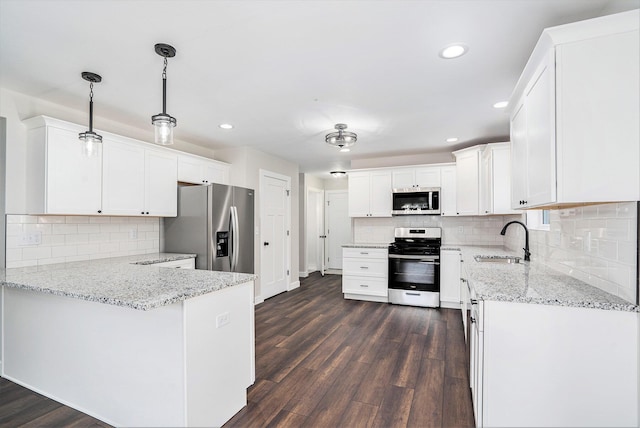 kitchen featuring sink, white cabinetry, decorative light fixtures, dark hardwood / wood-style floors, and stainless steel appliances