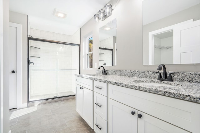 bathroom with a shower with door and vanity