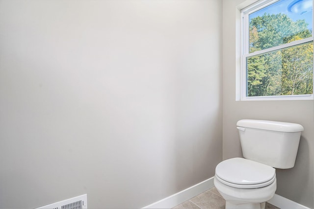 bathroom with tile patterned flooring and toilet