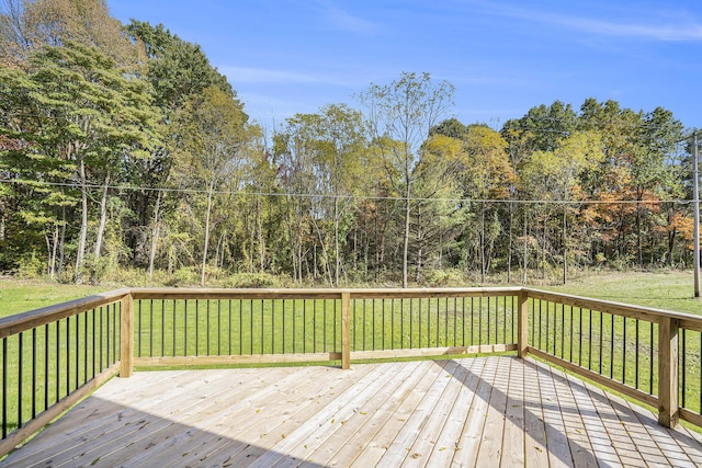 wooden deck featuring a lawn