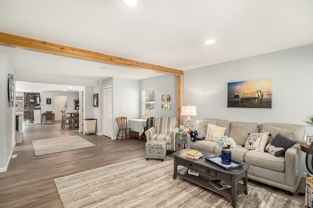 living room featuring beam ceiling and hardwood / wood-style floors