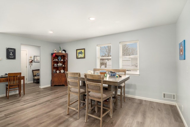 dining space with light hardwood / wood-style flooring