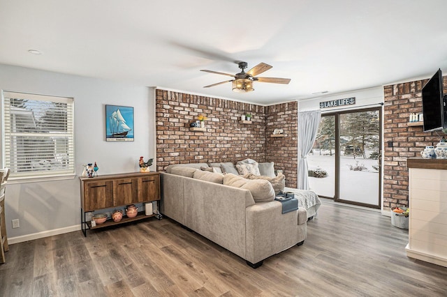 living room featuring ceiling fan and wood-type flooring