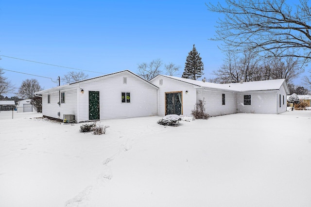 snow covered property featuring central AC unit