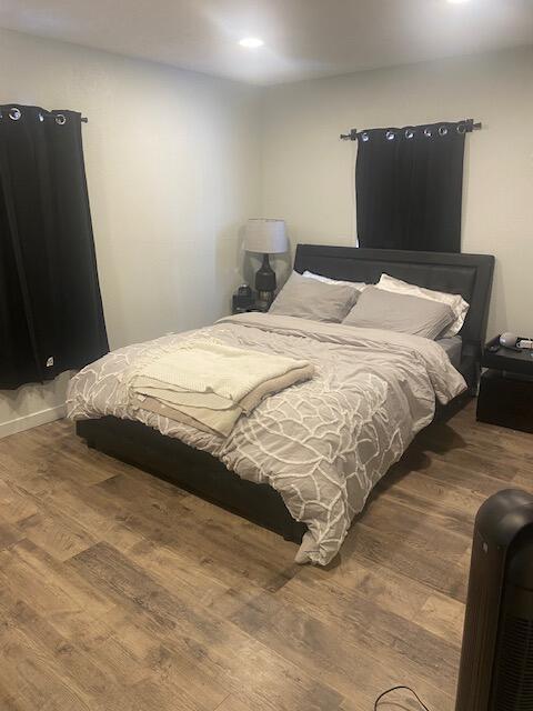 bedroom featuring wood-type flooring