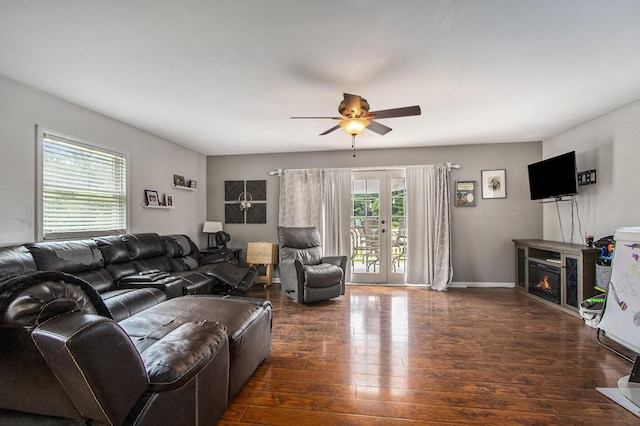 living room featuring french doors, ceiling fan, and dark wood-type flooring