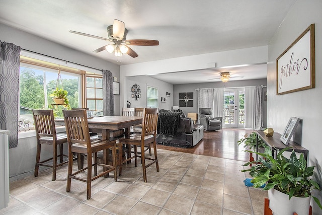 tiled dining area featuring french doors and ceiling fan