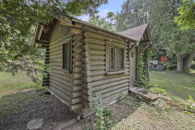 view of outbuilding featuring a yard