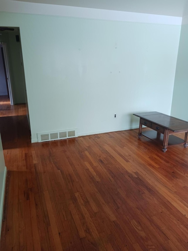 empty room with visible vents and hardwood / wood-style floors