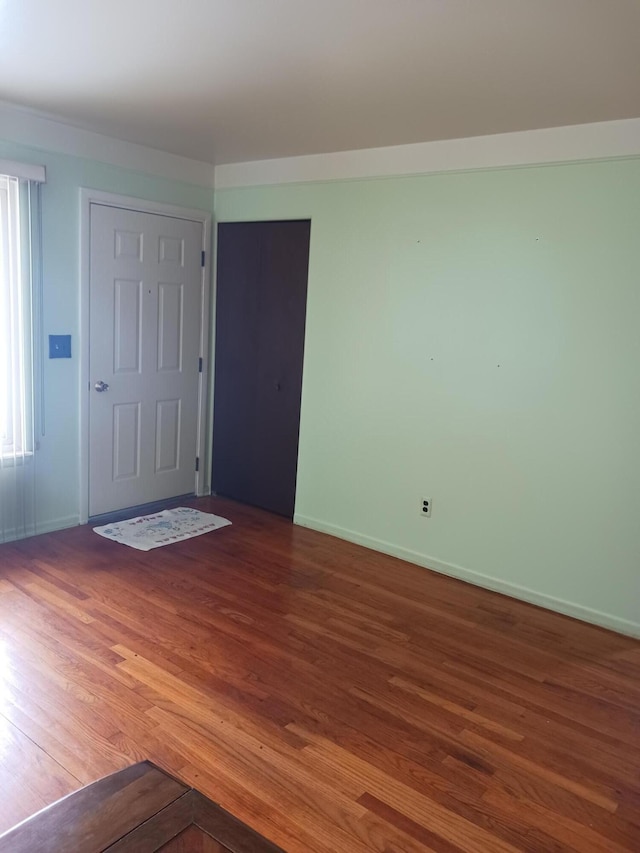 entrance foyer with wood finished floors and baseboards