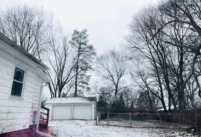 exterior space with a garage and an outdoor structure